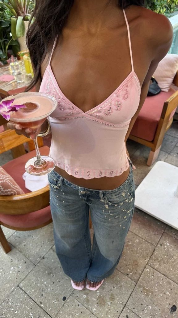 Pink beaded halter top with low-rise jeans for parties Pink beaded halter top with low-rise jeans for parties — Spring Break Night Outfits 2027