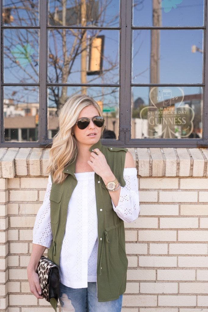 Olive green utility vest with white eyelet top and jeans Olive green utility vest with white eyelet top and jeans — St Patricks Day Outfits 2027