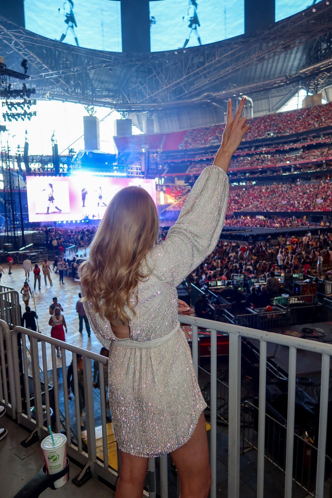 Sheer Sparkly Top and Black Leather Shorts, A Woman In A Long-Sleeved Sheer Sparkly Top and Black Leather Shorts, A Woman In A Long-Sleeved — Stadium Concert Outfits 2027