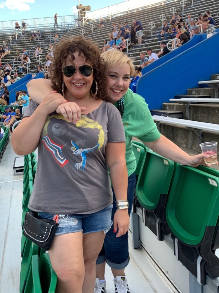 Black Cargo Pants with Graphic Top, The Other Wears A Green T-Shirt Black Cargo Pants with Graphic Top, The Other Wears A Green T-Shirt — Stadium Concert Outfits 2027