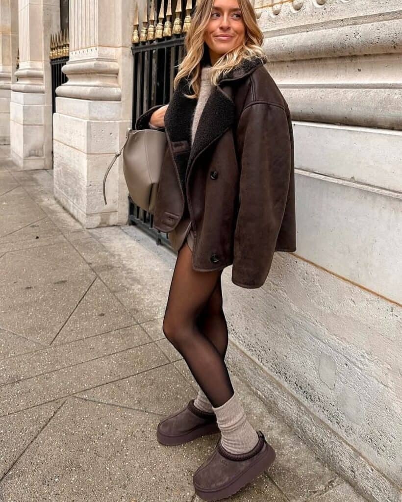 Shearling jacket and dark brown Uggs with mini shorts Shearling jacket and dark brown Uggs with mini shorts — Tasman Uggs Outfits 2027