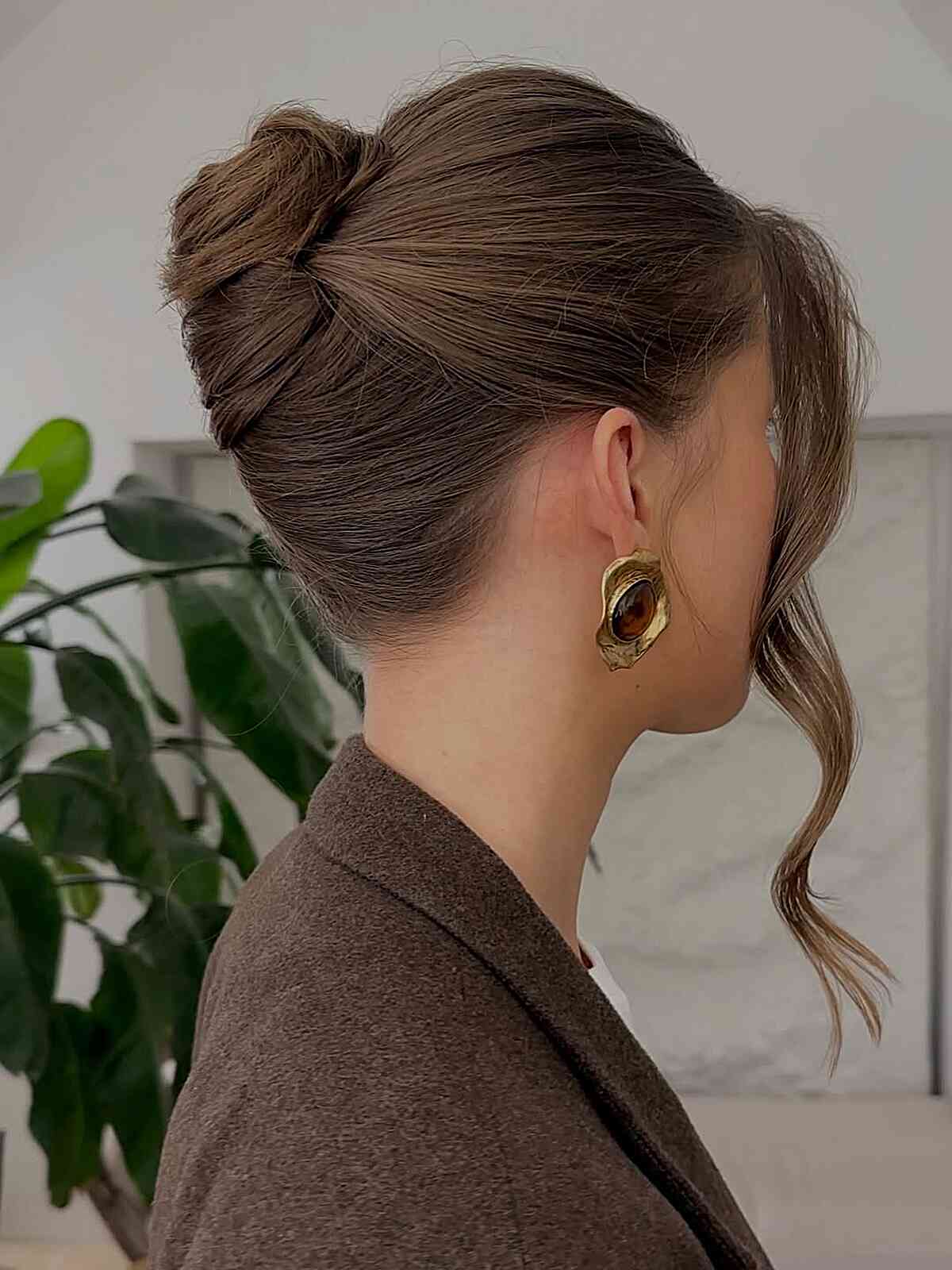 Voluminous Dark Brown Twisted Bun With Side Swept Bangs Voluminous Dark Brown Twisted Bun With Side Swept Bangs — Twisted Bun Hairstyles 2027