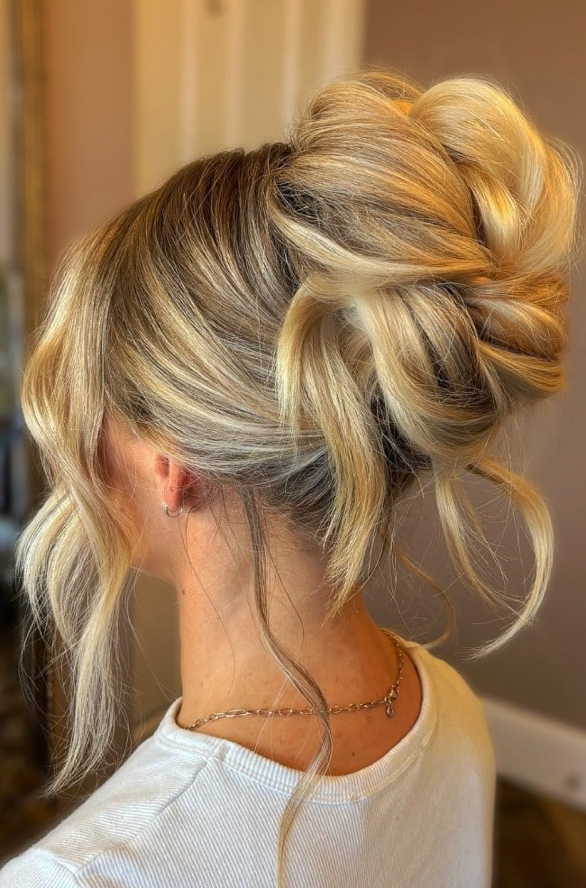 Messy High Twisted Bun With Loose Strands Messy High Twisted Bun With Loose Strands — Twisted Bun Hairstyles 2027