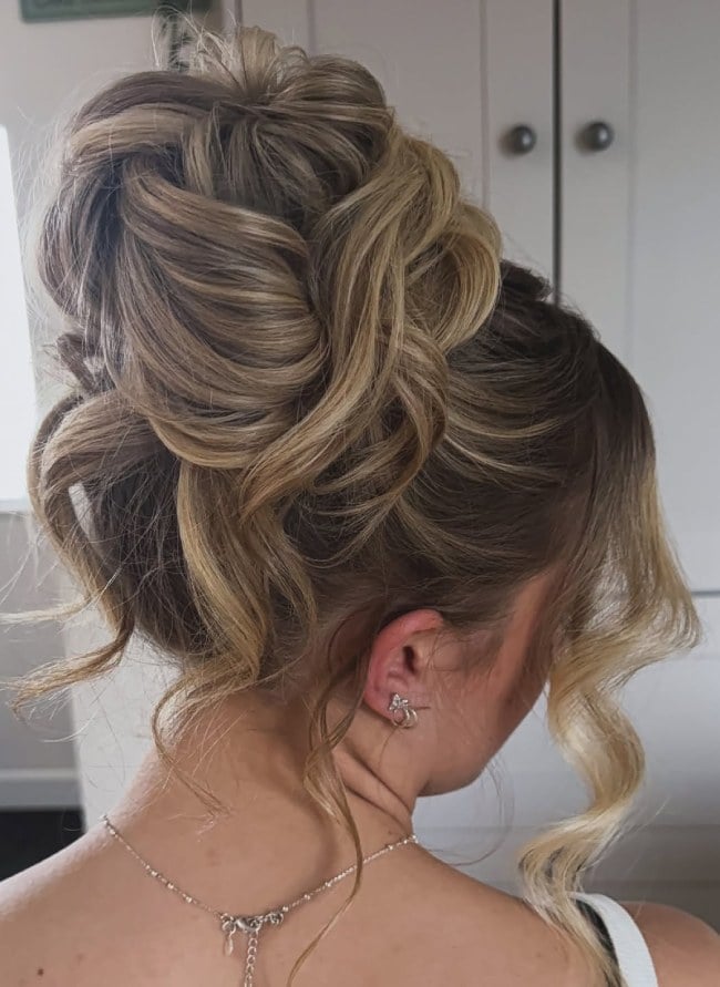 High Twisted Bun With Loose Wavy Tendrils High Twisted Bun With Loose Wavy Tendrils — Twisted Bun Hairstyles 2027