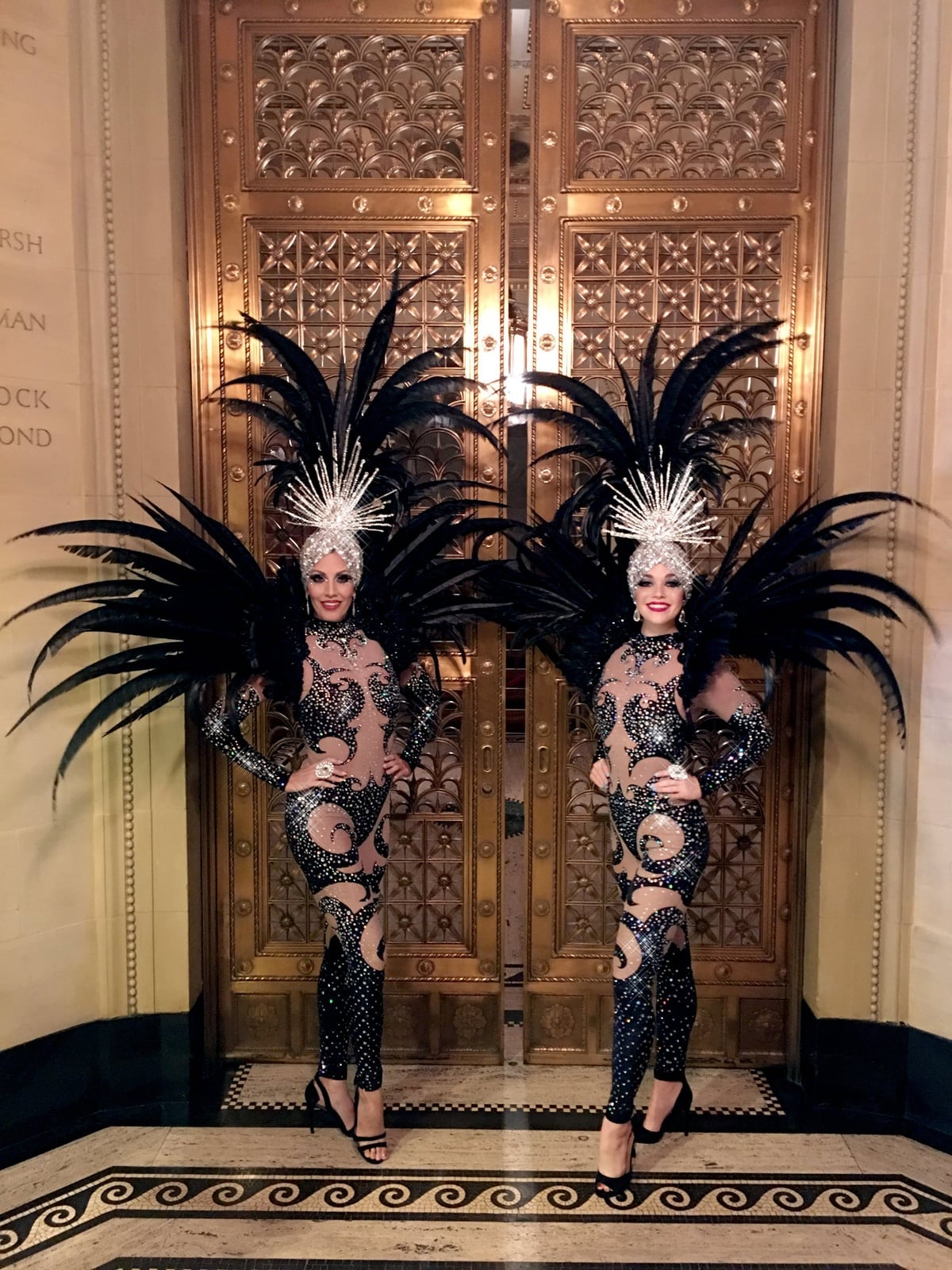 Black sequined bodysuits with elaborate feather headdresses Black sequined bodysuits with elaborate feather headdresses — Vegas Show Outfits 2027