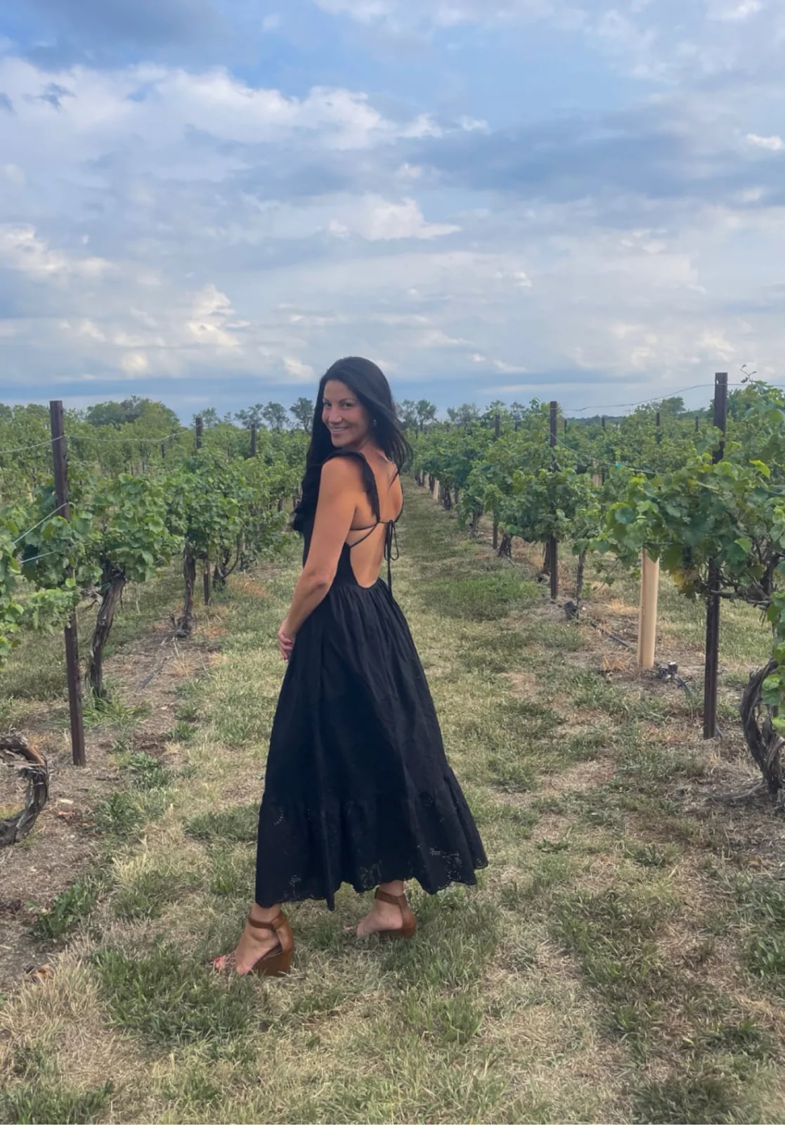 Black tiered maxi dress with open back for vineyard weddings Black tiered maxi dress with open back for vineyard weddings — Wedding Guest Outfits Vineyard 2027