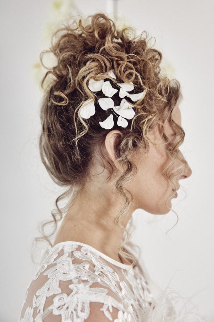 Light Brown Curly Updo with Floral Accessory Light Brown Curly Updo with Floral Accessory — Wedding Hairstyles 2027 with Curls