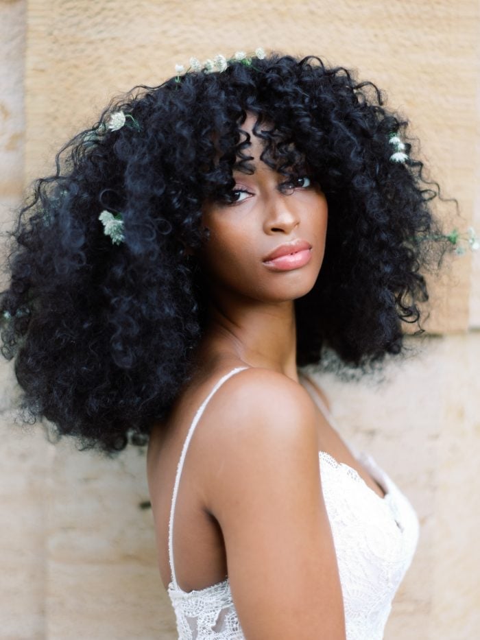 Collarbone Black Curly Hair With Curly Bangs and Flowers Collarbone Black Curly Hair With Curly Bangs and Flowers — Wedding Hairstyles 2027 with Curls