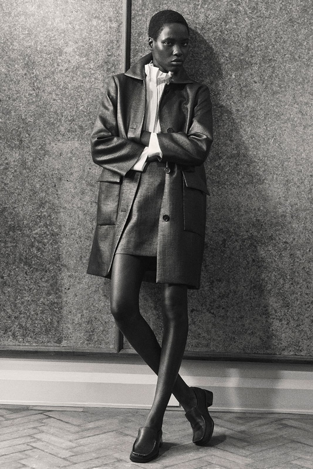 Dark oversized coat with white shirt and mini skirt Dark oversized coat with white shirt and mini skirt — Winter to Spring Transition Outfits 2027
