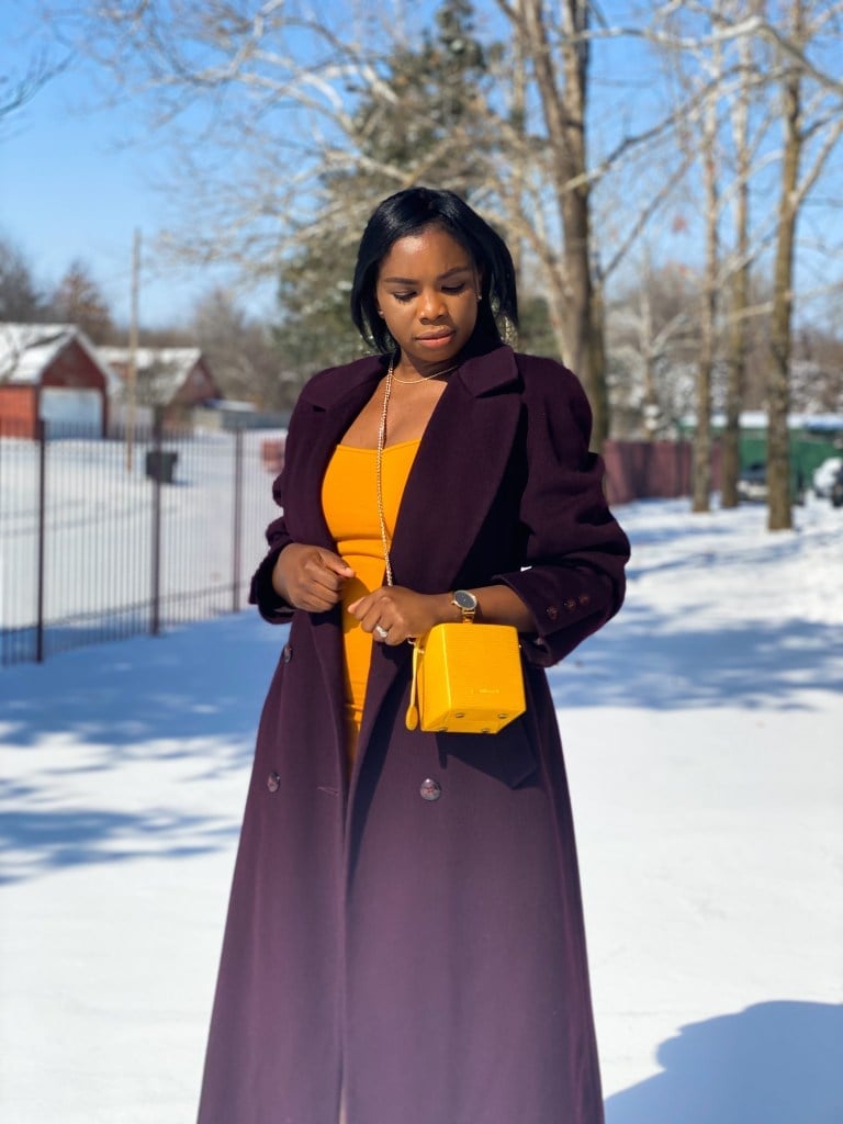 Plum wool coat over orange dress with yellow handbag Plum wool coat over orange dress with yellow handbag — Winter to Spring Transition Outfits 2027