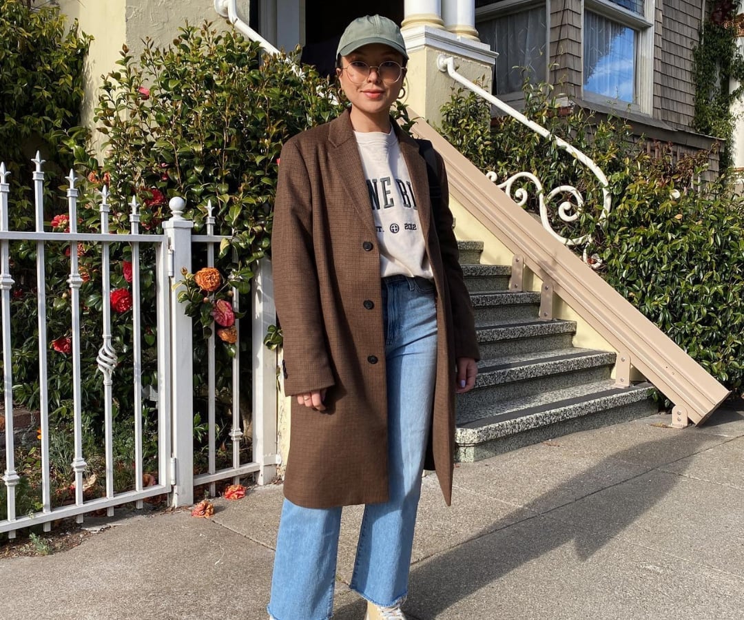Plaid wool coat over graphic tee and straight leg jeans Plaid wool coat over graphic tee and straight leg jeans — Winter to Spring Transition Outfits 2027
